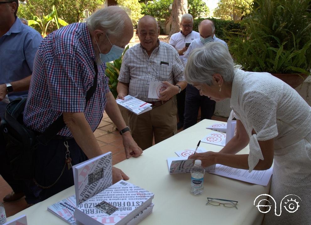 Malgara García Díaz firma ejemplares de su libro.